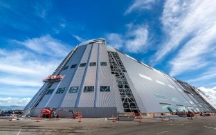 Exterior view of Hangar One under construction