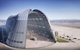 Exterior, aerial rendering of the hangar showing a plane inside