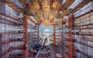 Interior view of the hangar under construction with scaffolding