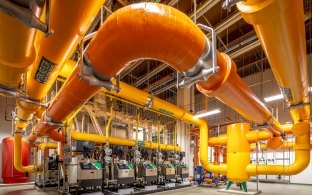 A central utility plant room showing large pipes and other equipment
