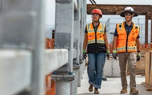 Two people walking a jobsite