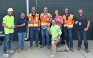 team members holding challenge coins