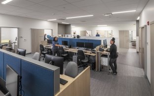Two people talking between cubicles
