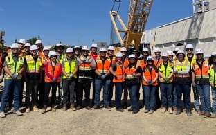 Group of people wearing PPE standing at a jobsite