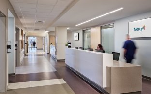 A long desk with people sitting at computers