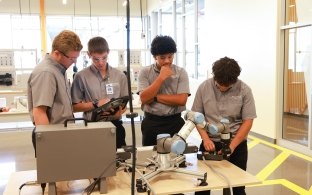 A group of people working in the manufacturing lab