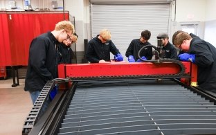 A group of people working in the manufacturing lab