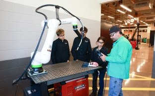 A group of people working in the manufacturing lab