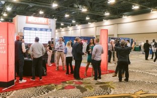 A group of people at McCarthy's DBIA booth in 2024. 