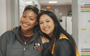 Two people smiling and posing for a photo