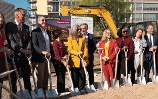 A group of people standing with ceremonial shovels