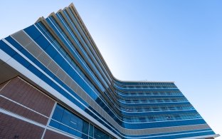 Looking up at the exterior of the hospital tower from the ground level