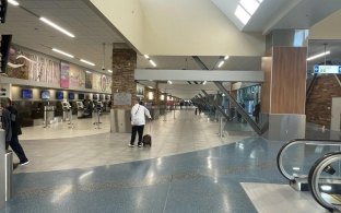 People walking toward the check in counter