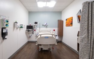 A patient bed inside of a hospital room