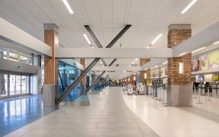 A view of the ticketing hall with the entrance on the left and kiosks on the right