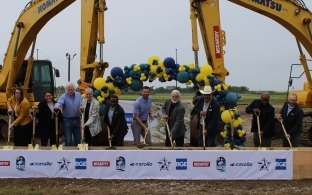 A group of people with shovels celebrating a groundbreaking