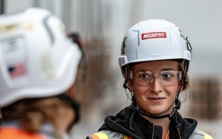 A group of people wearing PPE on a jobsite.