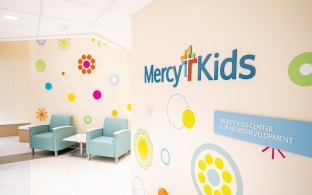 Waiting area with two chairs and colorful designs on the wall