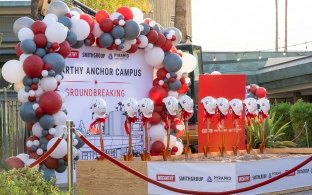 A staging area with shovels and a backdrop for a groundbreaking ceremony