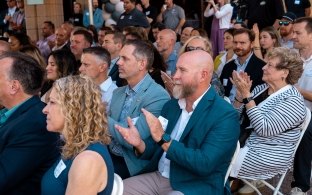 A group of people in the audience at a groundbreaking ceremony