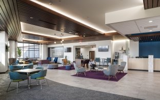A waiting area with multiple tables and chairs