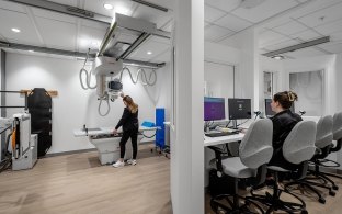 An imaging machine with desk and computer off to the side