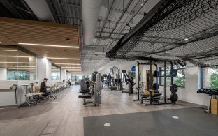 A large room with gym equipment like weights