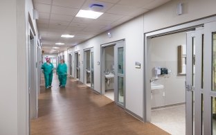 People wearing scrubs walking down a hallway