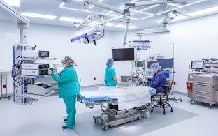 People wearing scrubs inside a procedure room