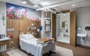 A patient room with a bed and sink