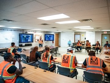 Construction workers in a meeting room. 