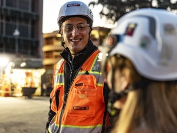 employee smiling at another person