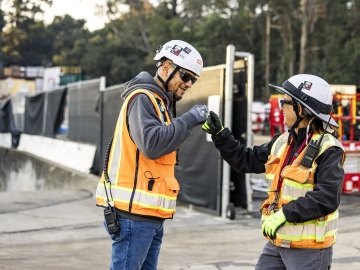 employees fist bumping on jobsite