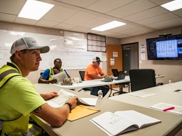 Construction workers in a meeting room. 