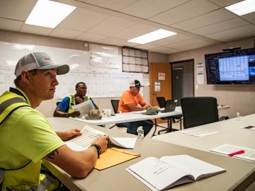 Construction workers in a meeting room.