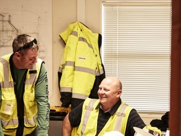 employees looking at each other talking in trailer