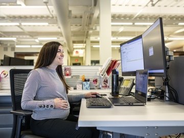pregnant woman sitting at a desk