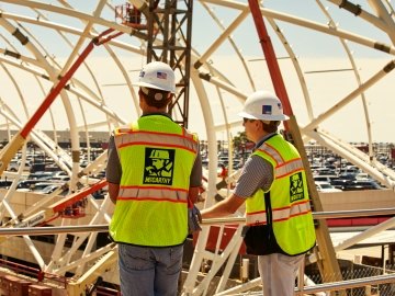 Two construction workers working at the Hartsfield-Jackson Airport.