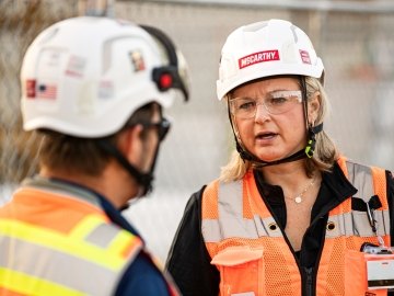 Two construction workers talking at a jobsite.