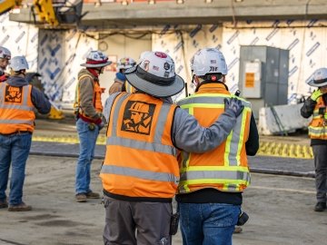 Employee giving pat on the back to another employee