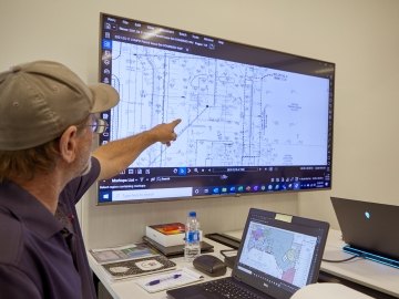 employee pointing to screen
