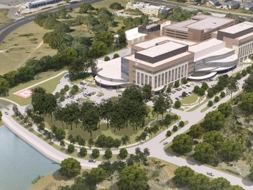 Aerial rendering of the hospital with lots of trees and a pond
