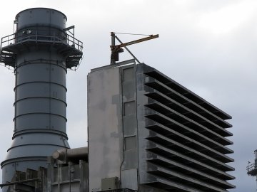 Gas combustion turbine and exhaust tower at industrial power plant