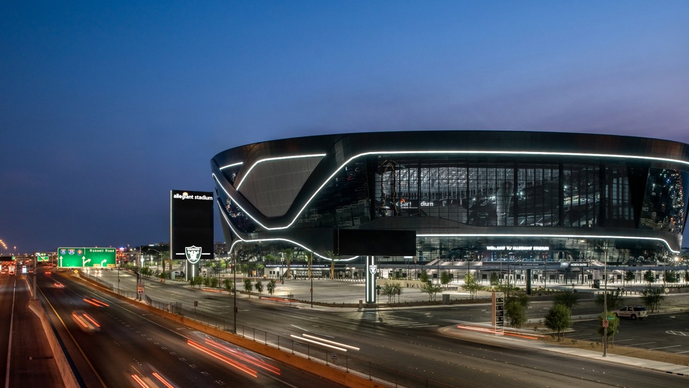 Aerial view of the stadium at night, with the highway in front