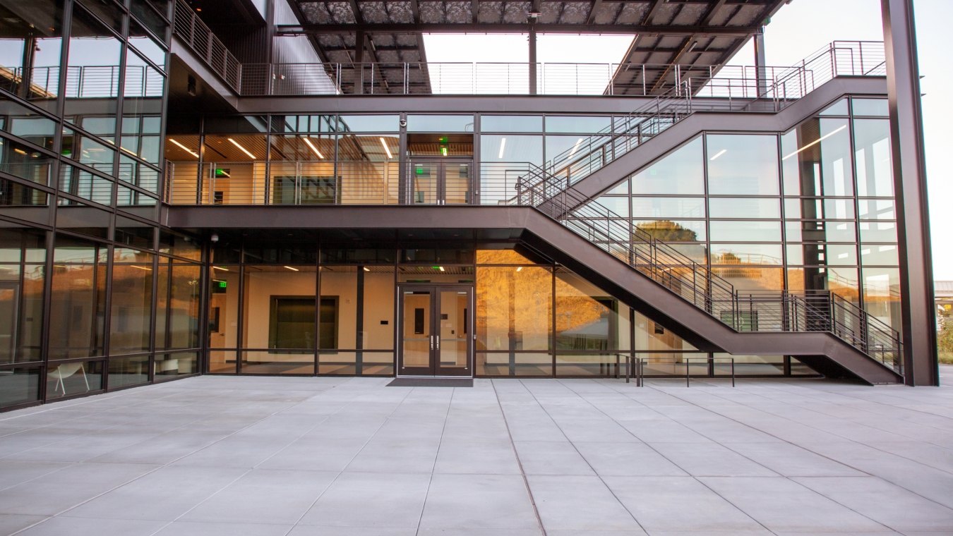 A staircase and large glass windows on the exterior of a building.