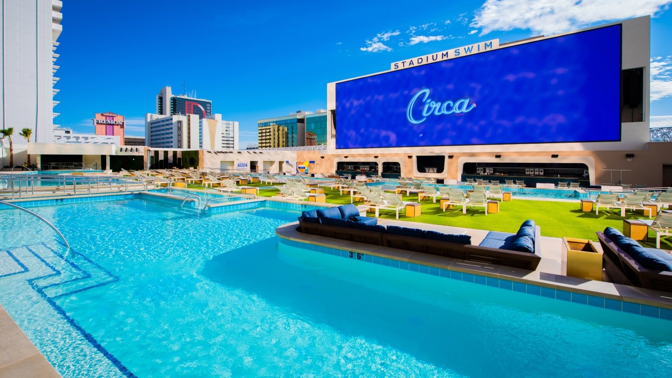 Rooftop swimming pool with a large screen reading "Circa"