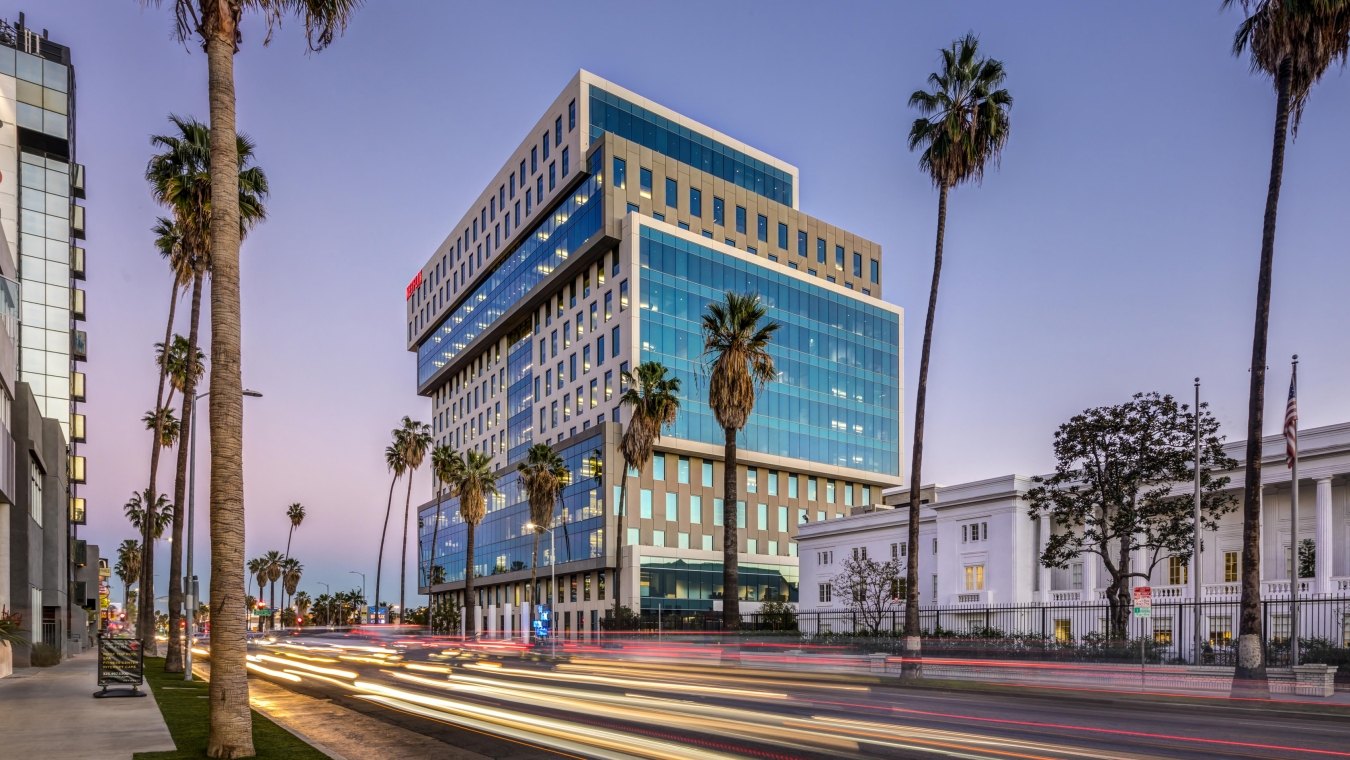 Sunset Bronson Studios ICON Office Tower with surrounding buildings, roadway and palm trees