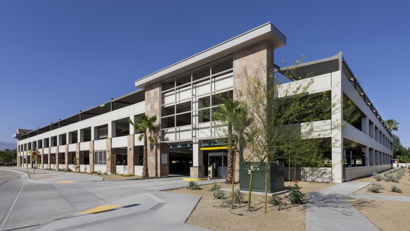 Outdoor entrance to the parking garage with palm trees out front