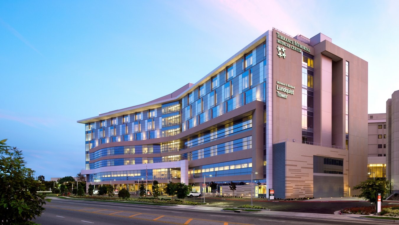 Outdoor image of the medical center with blue windows and a blue sky