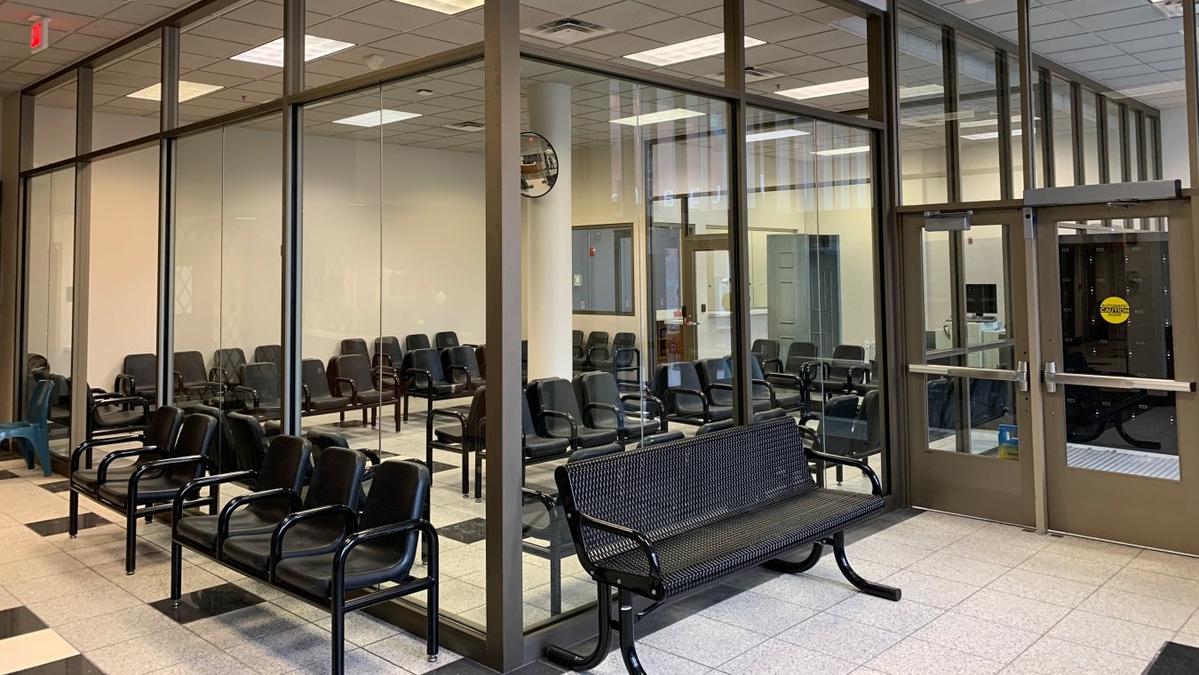 Interior view of a waiting room with chairs.